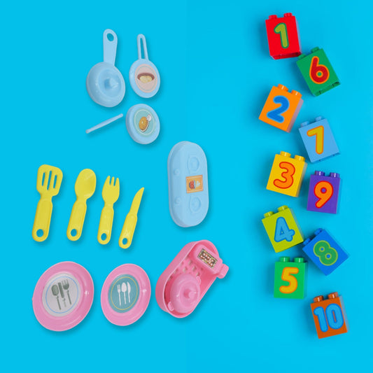 Detailed view of play kitchen set with colorful utensils and storage basket.