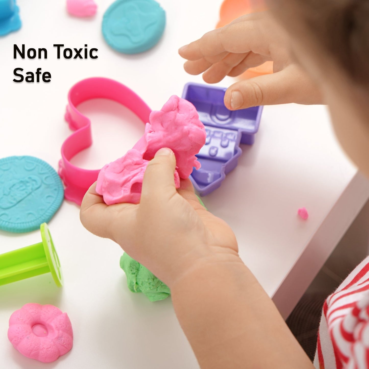 Kinetic sand in a container with toy molds.