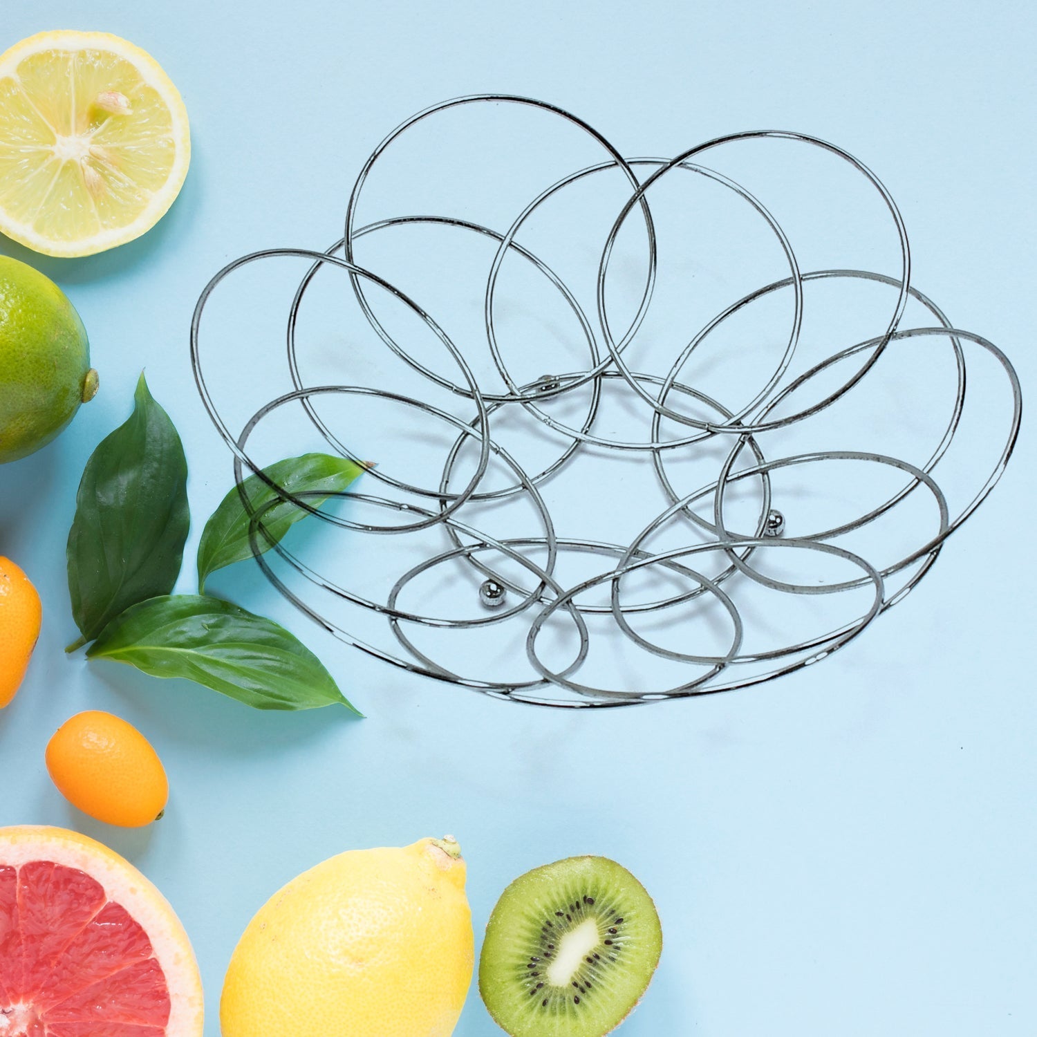 Steel fruit storage bowl with fresh fruits.