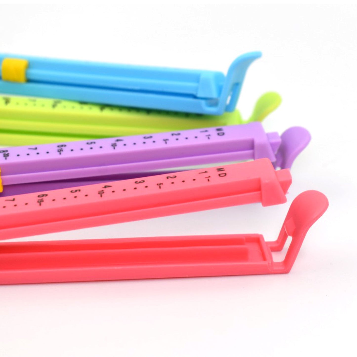 Plastic clip sealers for food pouches, large and multicolor.