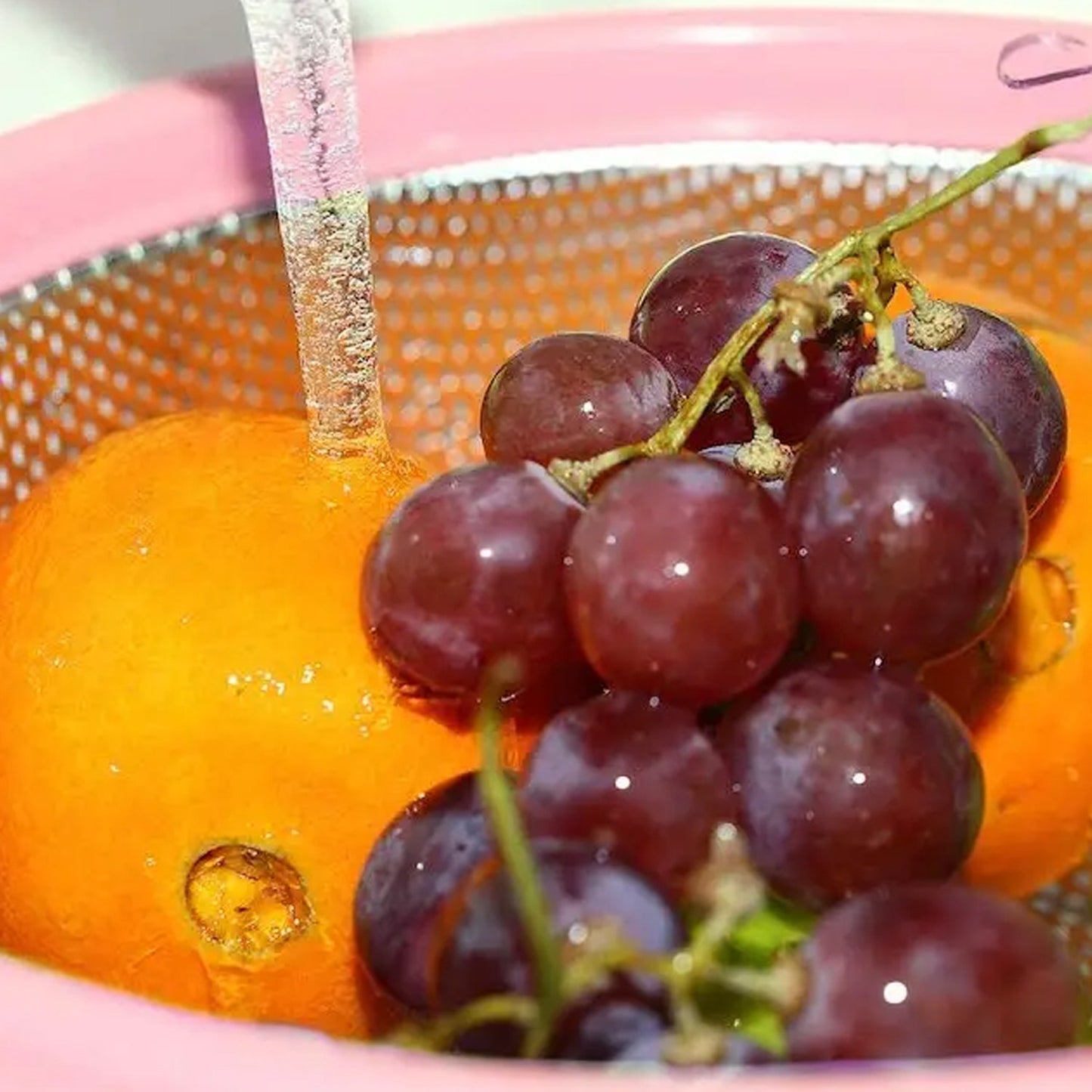 Colander being used for washing berries