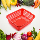 Rectangular plastic drain basket for washing fruits and vegetables in the kitchen sink.