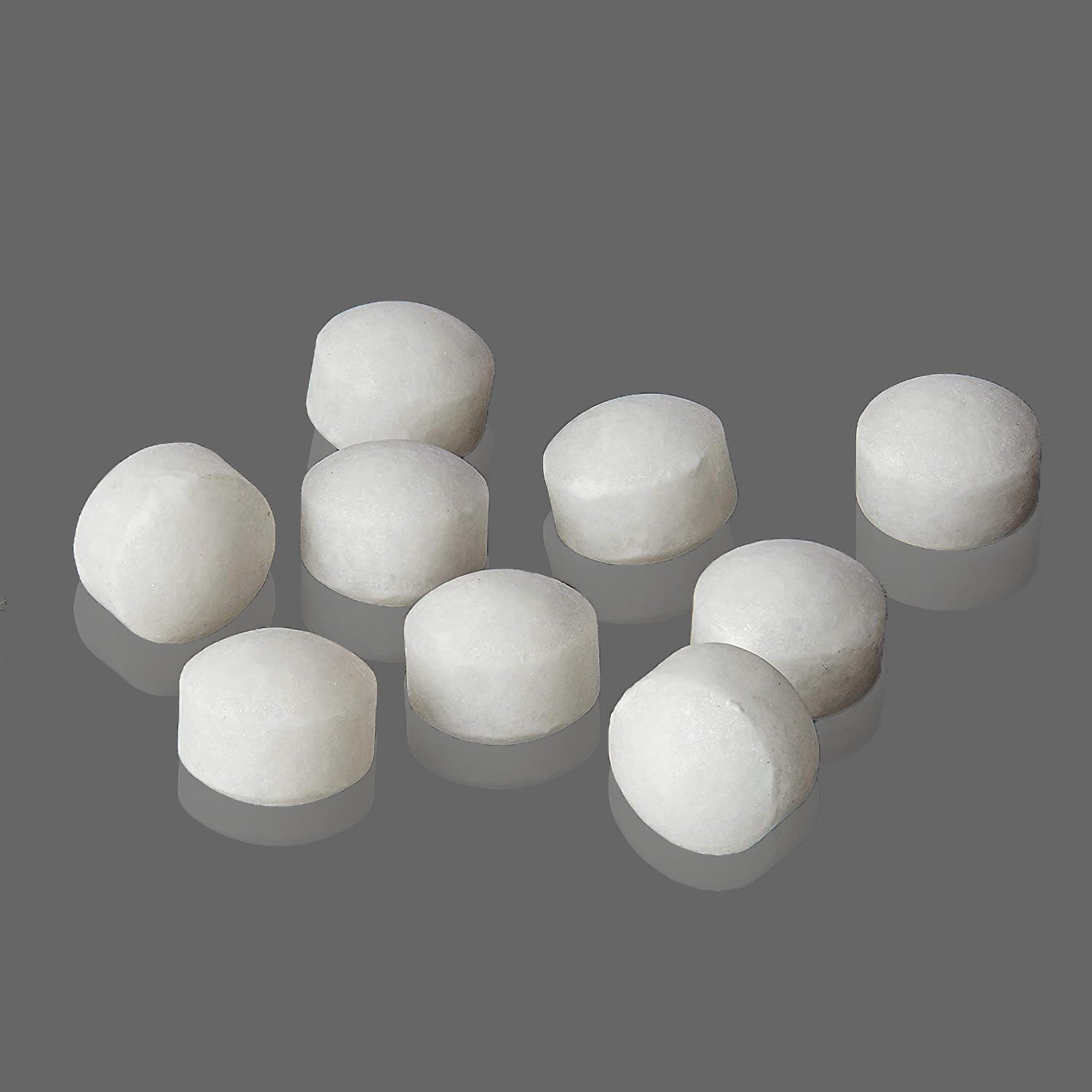 White naphthalene balls in a 100 grams pack for odor control.