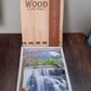 Elegant vertical wooden scenery art with hooks for wall decor.