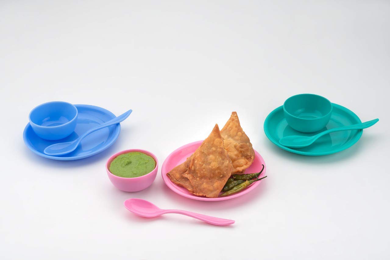 Snack set with a spoon, bowl, and dish on a table.