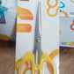 Stainless steel scissors with a focus on their sharp blades and ergonomic handle for precision cutting