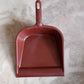 Sturdy plastic dustpan with handle, great for all-purpose cleaning.