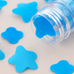 Flower-shaped paper soap strips in a compact test tube bottle.