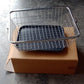 Dish drainer rack with drip tray and utensil holder, ideal for kitchen use