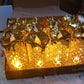 Collection of gold LED candles in various sizes, ideal for enhancing table settings and creating ambiance.