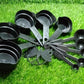 Plastic measuring cups and spoons set with a butterfly-shaped holder, highlighting its design