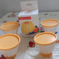 Set of pudding molds with covers for homemade desserts.