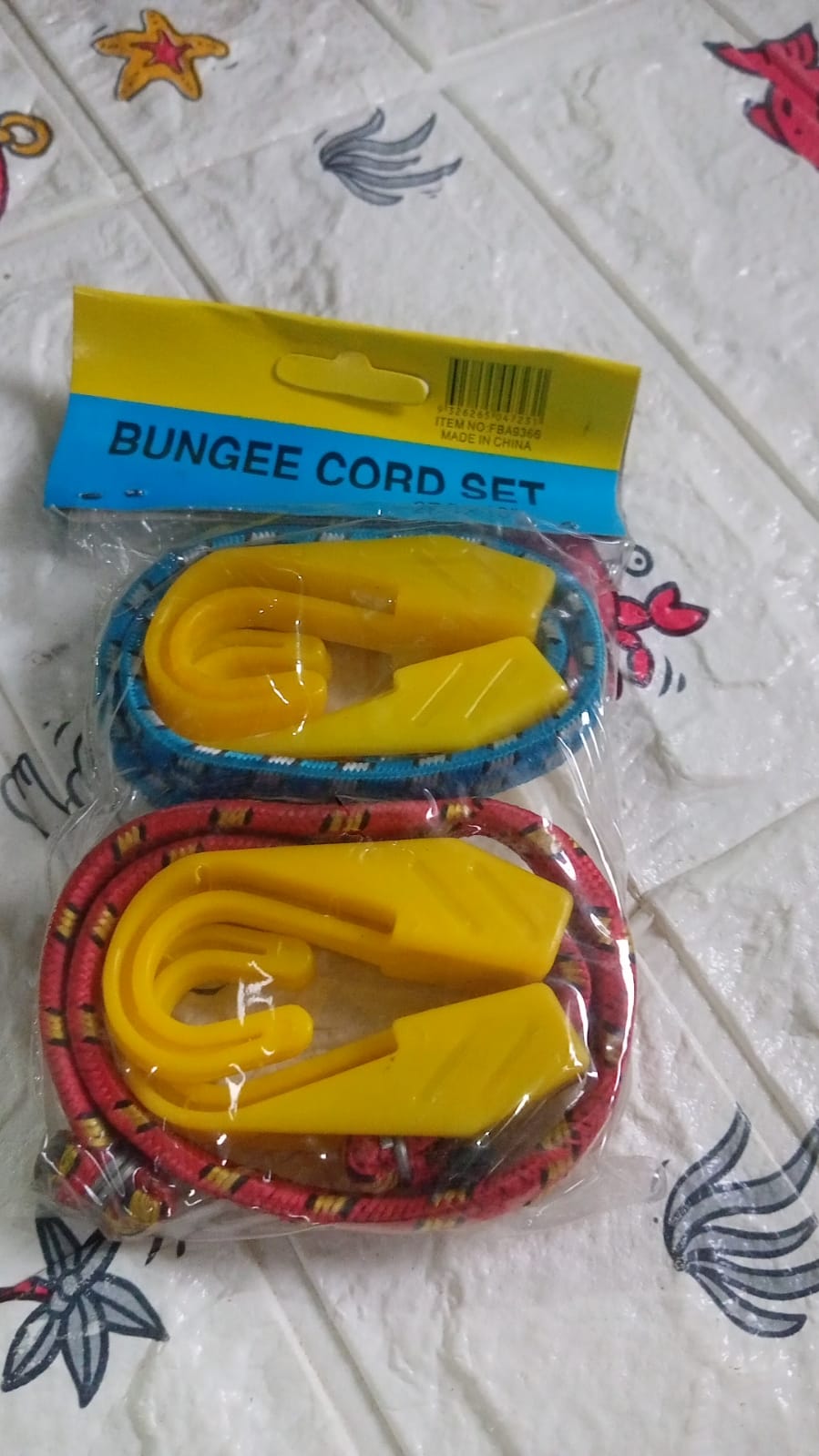 Close-up of strong plastic J shape hooks attached to bungee cord.